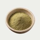 bulk white kratom powder presented in a wooden bowl